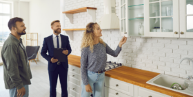 Three people walking through an apartment