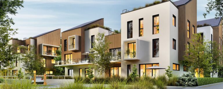 Modern multi-story apartment buildings with wood and white facades, balconies, and landscaped trees at dusk
